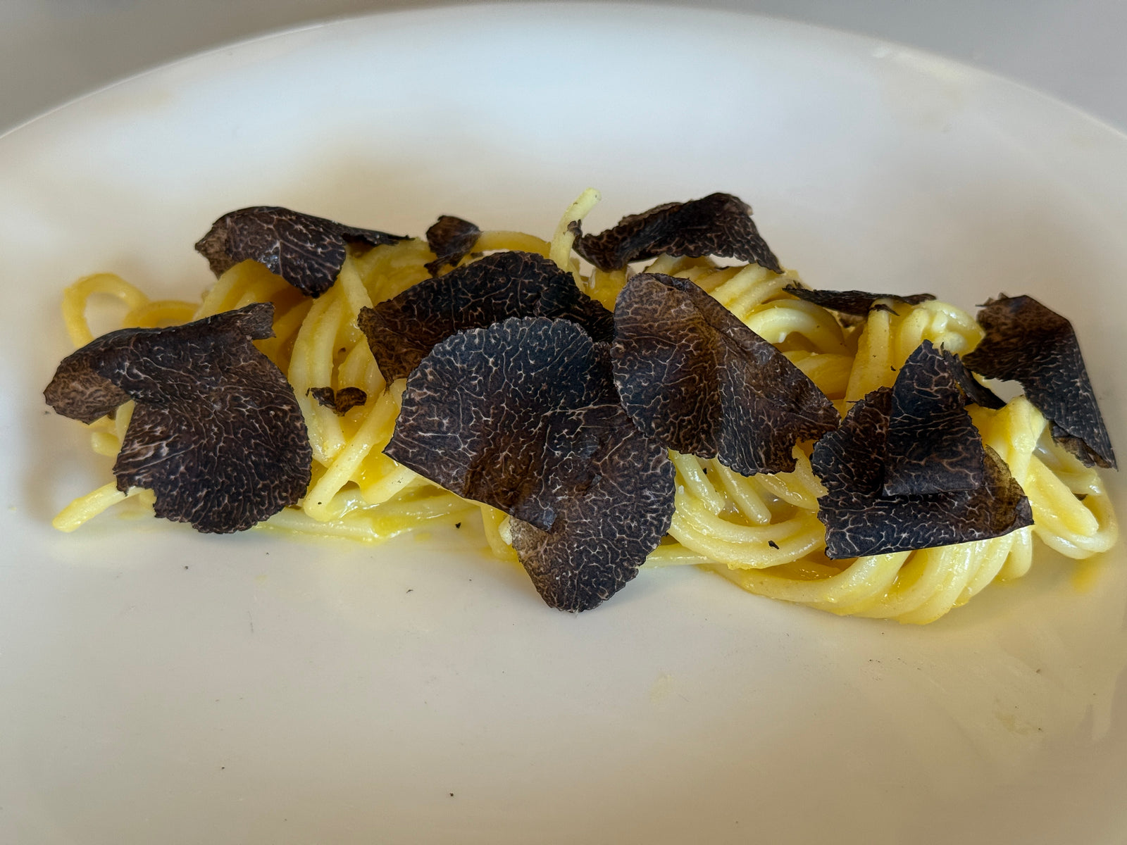 Tagliatelle buried under shaved black truffle